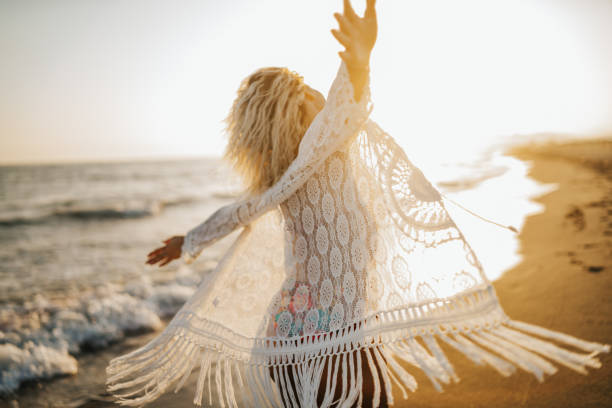 istock Happy woman on the beach 1300087502