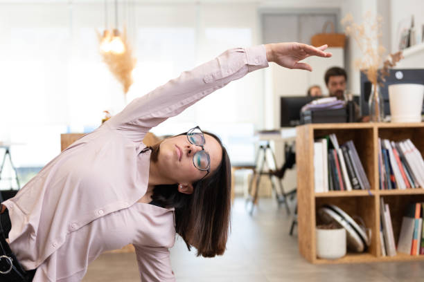 istock Woman stretching in the office 1300088999
