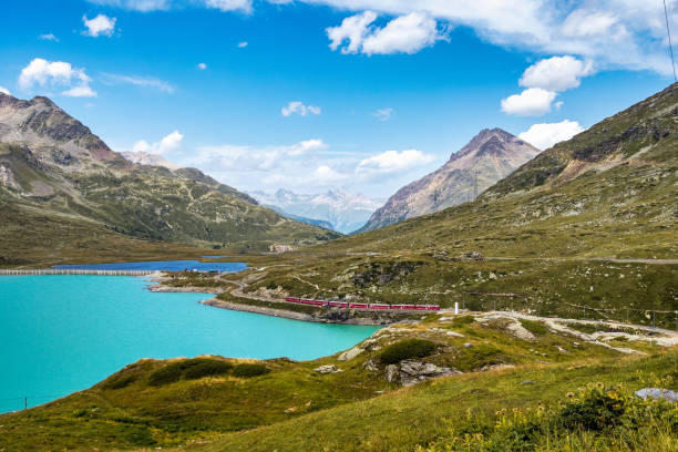 bernina express at the white lake in ospizio bernina, engadin, switzerland - white lake imagens e fotografias de stock