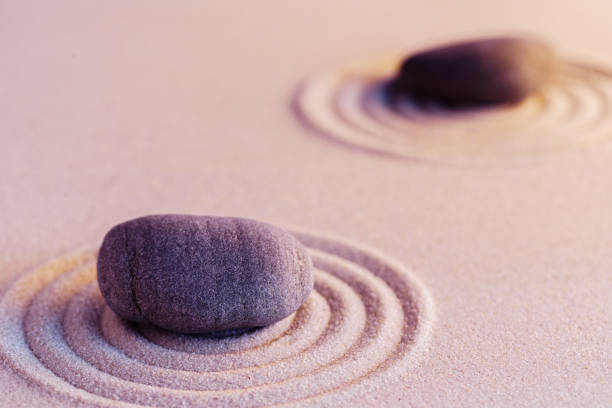 istock Zen garden stones on sand with ornament 1300092381