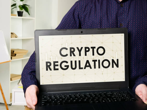 istock Man shows laptop with crypto regulation rules. 1300094799