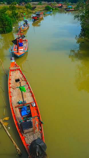 Thai fishing boats. Colorful boats lined up in the river.Mae Klong river/THAILAND,12/15/2019