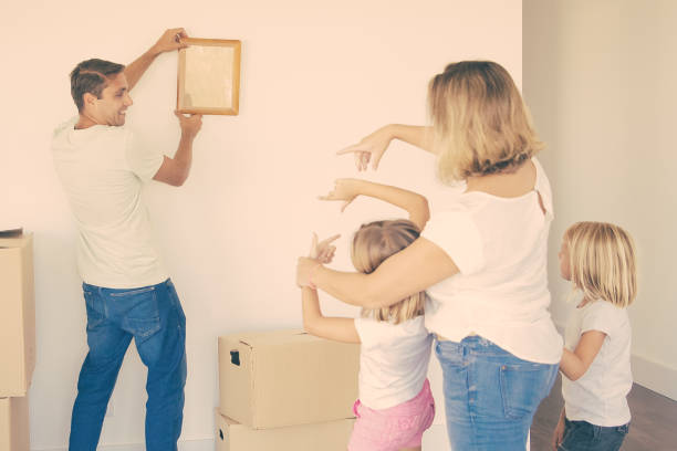 istock Caucasian dad in casual clothes hanging up empty frame on wall 1300097787