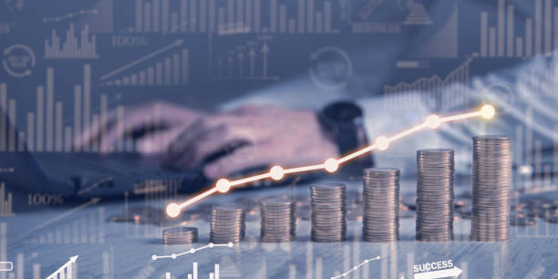 istock Man with a stack of coins with a graph of profit. 1300098086