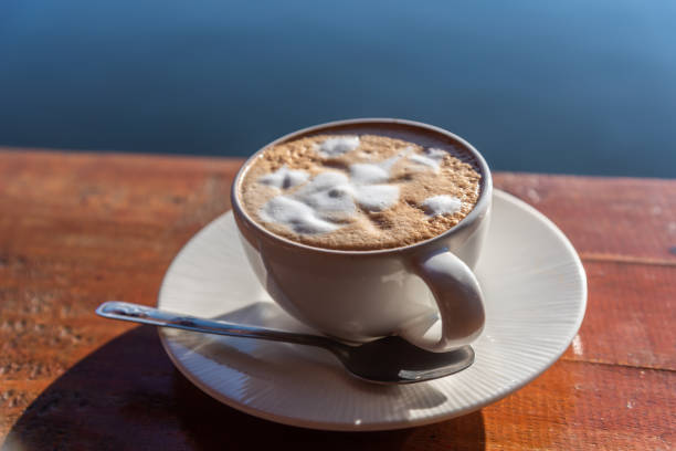 istock Hot coffee latte in morning sunrise light. 1300099175