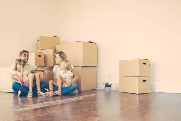 istock Happy young family relaxing on floor during relocation 1300099871