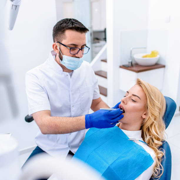 istock Woman having teeth examining at dentist 1300100489