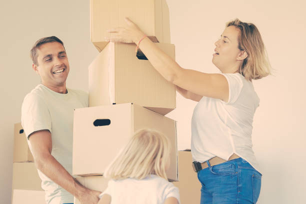 istock Happy father holding stack of boxes and smiling 1300100799