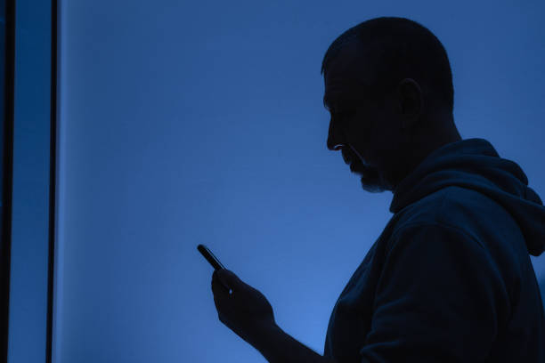 istock Silhouette of a man with a phone 1300101014