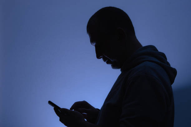 istock Silhouette of a man with a phone 1300101054