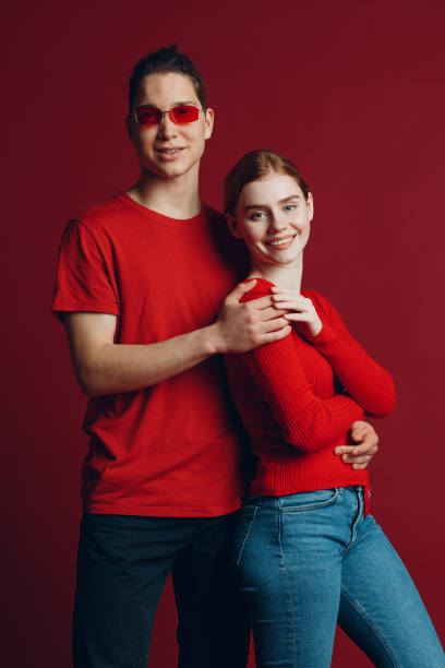 istock Beautiful young smiling couple hugging on red background. Valentine's day concept. 1300102201