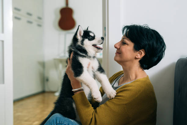 istock woman embracing with her dog 1300103453