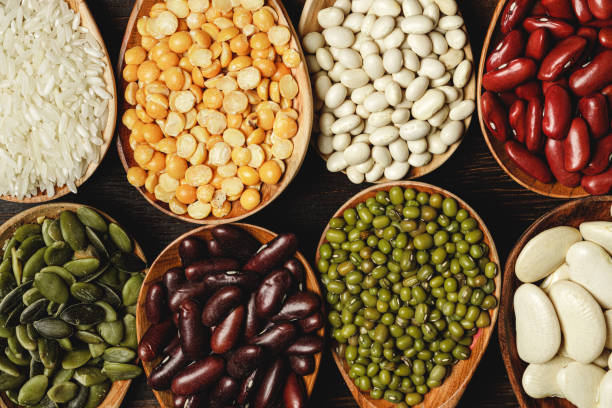 istock dried beans in wooden spoons on the table 1300103555