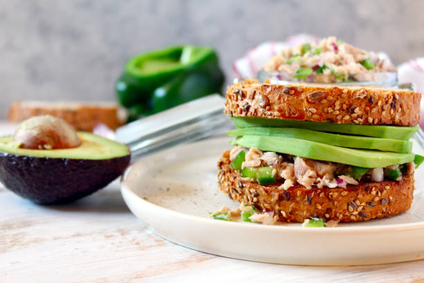 Sandwich with tuna, avocado and vegetables for snack or lunch.