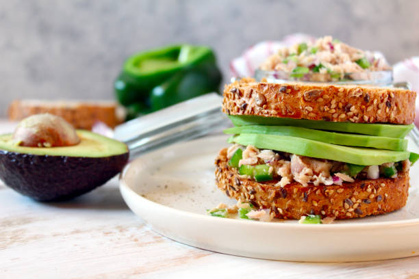 Sandwich with tuna, avocado and vegetables for snack or lunch. stock photo