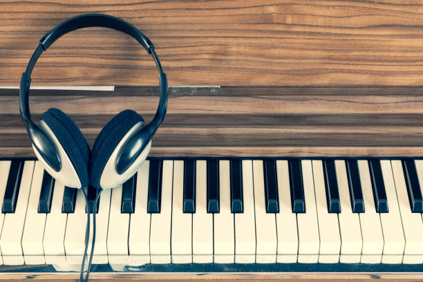 istock headphone on piano keys. music background 1300104784