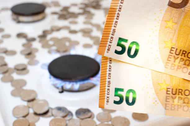 50 euro bills and a gas burner with fire. Natural gas and utilities prices in Europe. stock photo