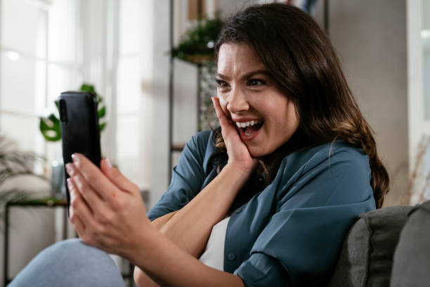 istock Happy young woman using the phone at home. 1300105076