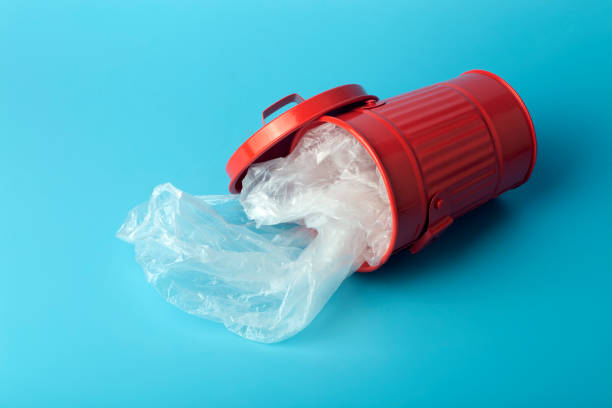 istock Plastic trash and waste in a trash bin on a blue background. Waste and plastic sorting and recycling concept 1300106227