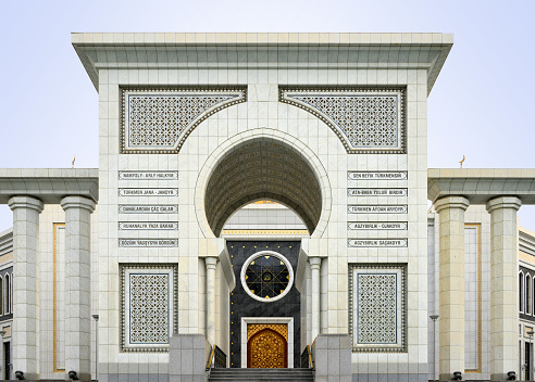 Gypjak, Ashgabat, Turkmenistan:  triumphal arch portal at the Turkmenbashi Ruhy Mosque / Kipchak Mosque. Mixing Ottoman, Persian, Hispano-Moorish and neoclassical influences, this monumental building was designed at the request of President Saparmurat Niyazov. The Arabic word in the center reads God (Allah) and the façade includes verses from the Book of the Soul, the Ruhnama.