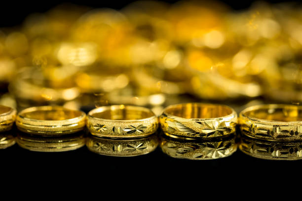 group of many design gold rings group of many design gold rings on black background best gold ira group stock pictures, royalty-free photos & images