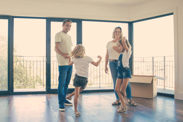 istock Joyful kids dancing and jumping in empty room 1300108882