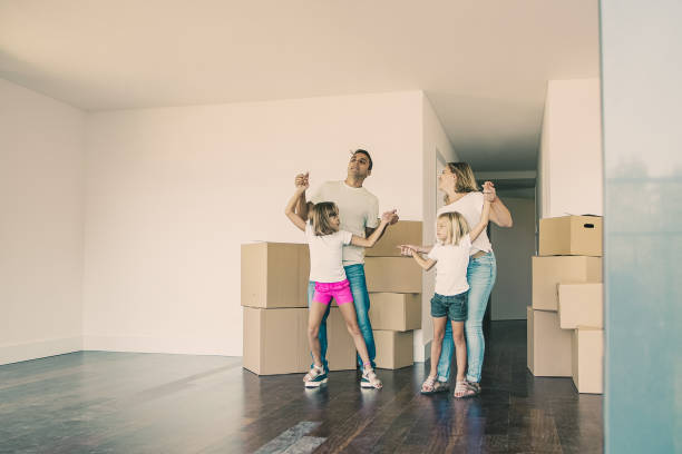 istock Cheerful parents and daughters dancing and having fun 1300109085