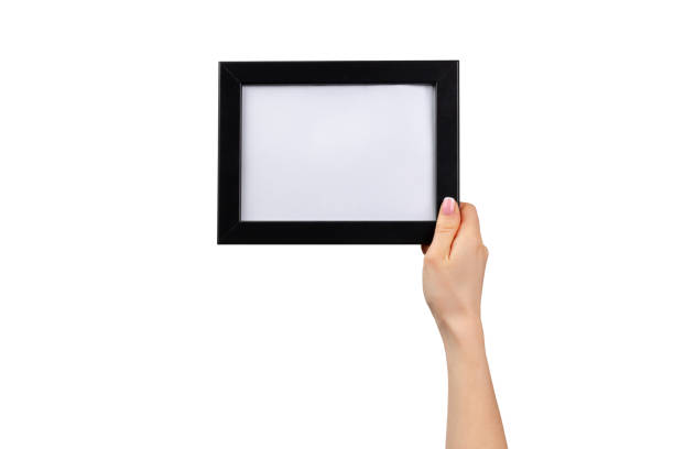 istock Female hands holding photo frame isolated on white 1300110867