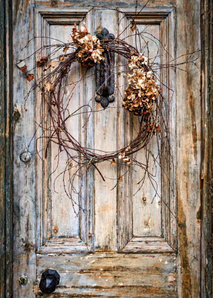 istock Dead Wreath On Faded Door 1300111666