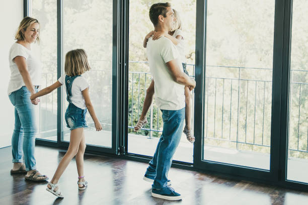 istock Happy father with daughter standing near open balcony 1300112371