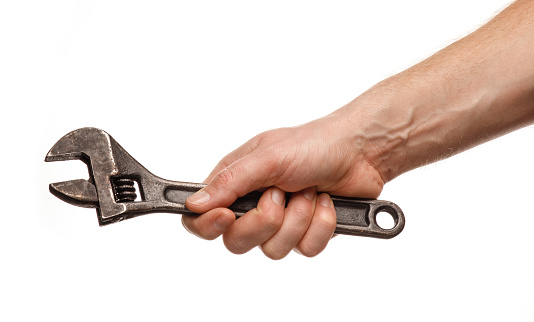 Hand holding a wrench