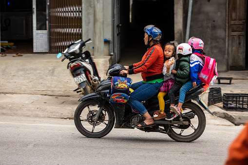Ha Giang, Ha Giang, Vietnam - November 13, 2019: With kids overloaded motorcycle in Ha Giang in Vietnam