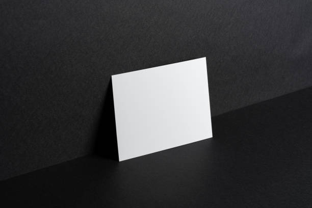 istock White businesscards on black background close up 1300114979