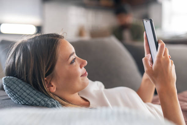 istock Pretty woman using mobile phone 1300115008
