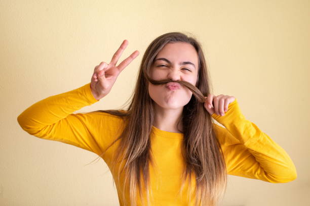 istock Young woman having fun playing with her hair 1300116055
