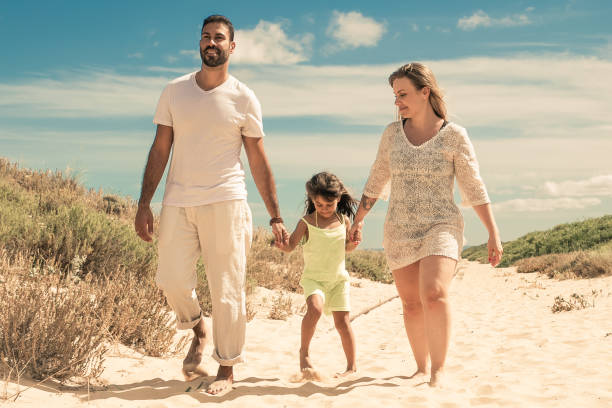 istock Happy parents and cheerful kid wearing summer clothes 1300116094