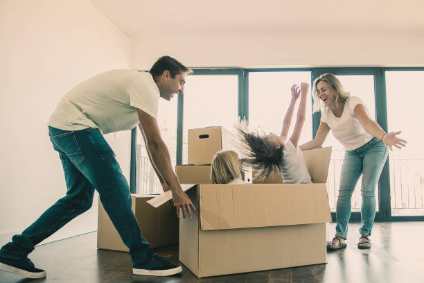istock Kids bursting out from carton box 1300116705