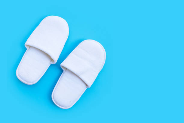 istock Hotel Slippers on blue background. 1300117956