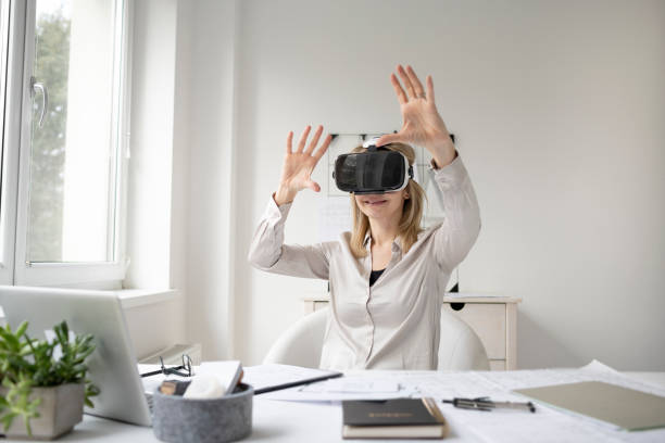 istock beautiful young female architect with virtual reality goggles 1300118605