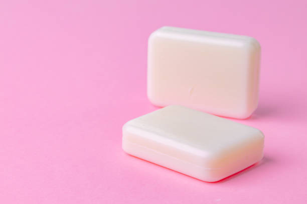 istock Soap bar isolated on pink background. Close up. 1300119020