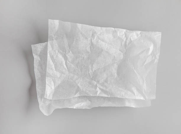 istock crumpled sheets of white baking paper on grey kitchen table, top view 1300120044