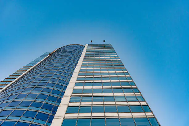 Bottom view of modern skyscrapers in business district against blue sky, skytower blue sky background. High quality photo