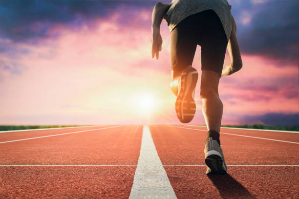 istock Sprinter leaving starting blocks on the running track closeup on shoe. 1300121519