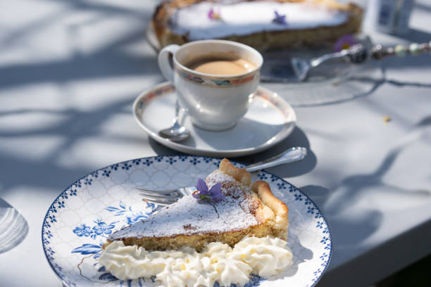 Fresh self made easter pie with flower decoration and coffee outdoor. stock photo