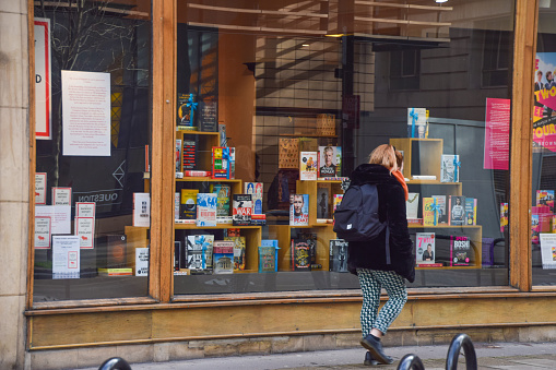 London, United Kingdom - February 2 2021: A woman walks past the Waterstones bookstore in Gower Street, Bloomsbury.