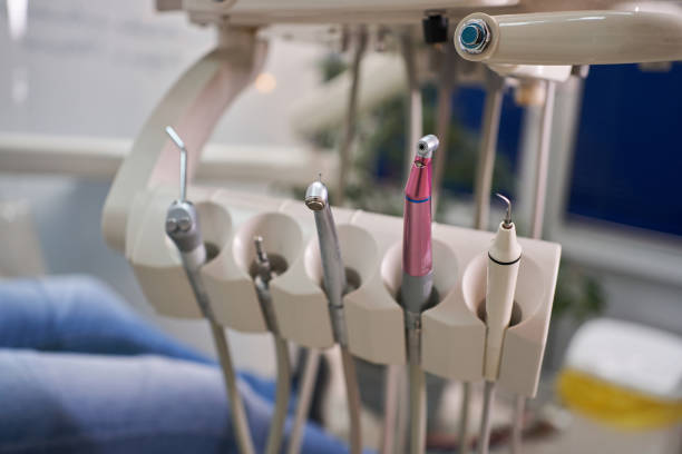 Dental drills and a air/water blower hanging on a place at dentist’s chair Dental drills and a air/water blower hanging on a place at dentist’s chair dental drill stock pictures, royalty-free photos & images