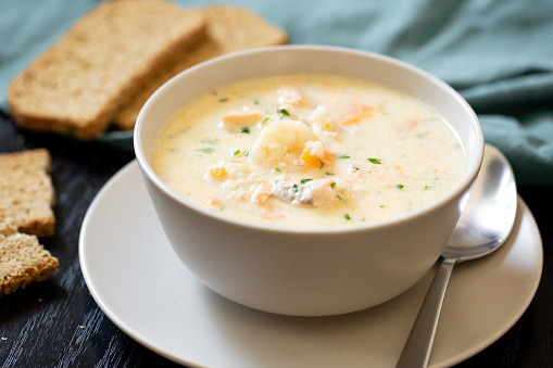 Traditional dish seafood chowder with slices of soda bread