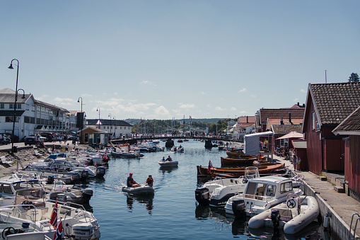 July 16-2020. Kragerø, Norway: A wonderful summer day in the idyllic town of Kragerø. Boats are moored on the piers, and people enjoy themselves at sea. This is the southernmost town in Telemark county.