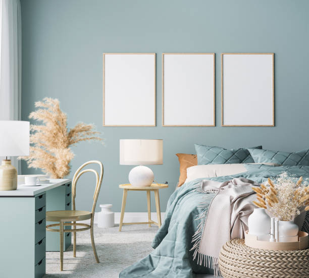 istock Blue Scandinavian bedroom with three vertical frames in bright design, poster mock up on boho wall background 1300125986