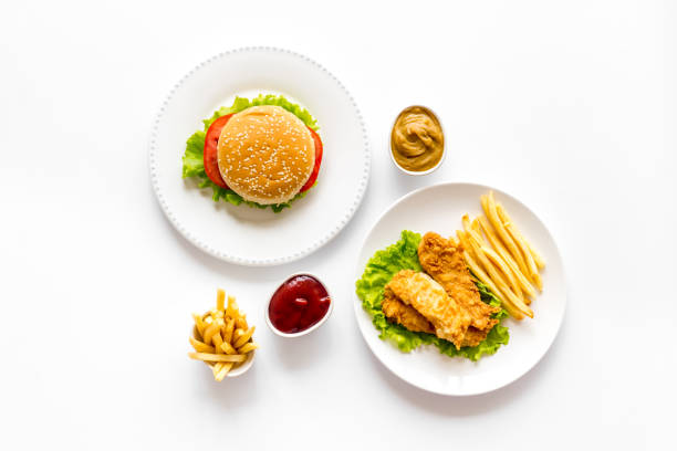 istock Fast food flat lay set. Burger with fried potatoes and chicken, top view 1300130153